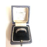 Unhallmarked white gold half eternity diamond ring. Size K/L, one replacement stone in paste.