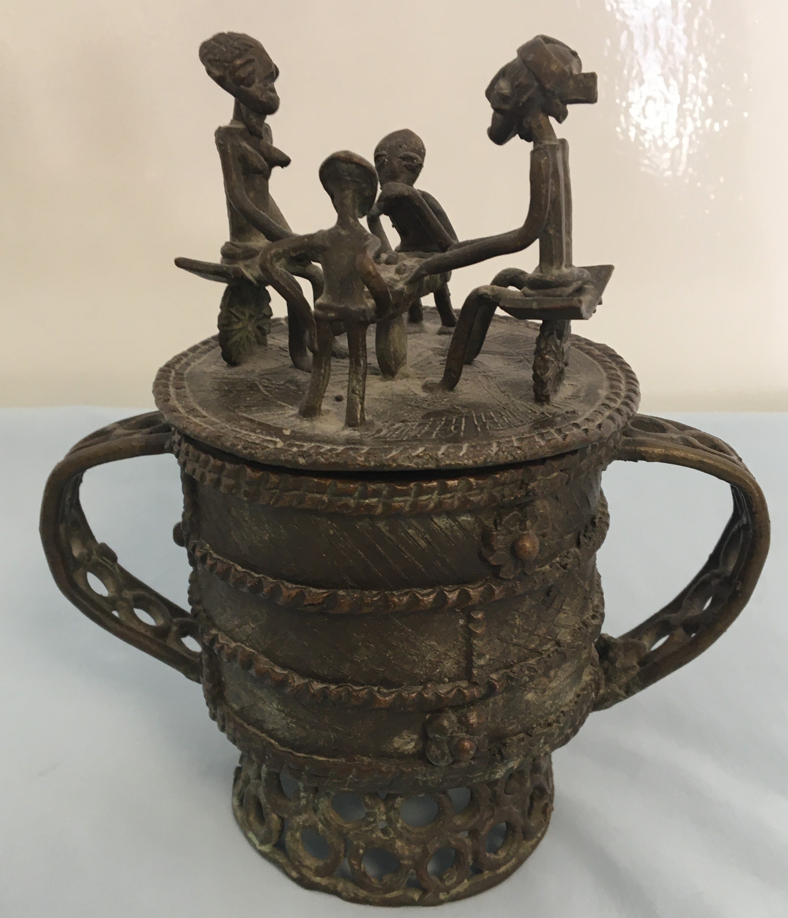 Benin Bronze Lidded Cup the lid with people sat around a table.