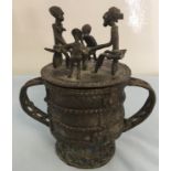 Benin Bronze Lidded Cup the lid with people sat around a table.