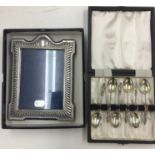 HM silver photo frame and cased set of HM silver Apostle spoons.