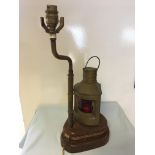 Lamp in the form of a brass Port ships lamp with a rope edged pulley base.