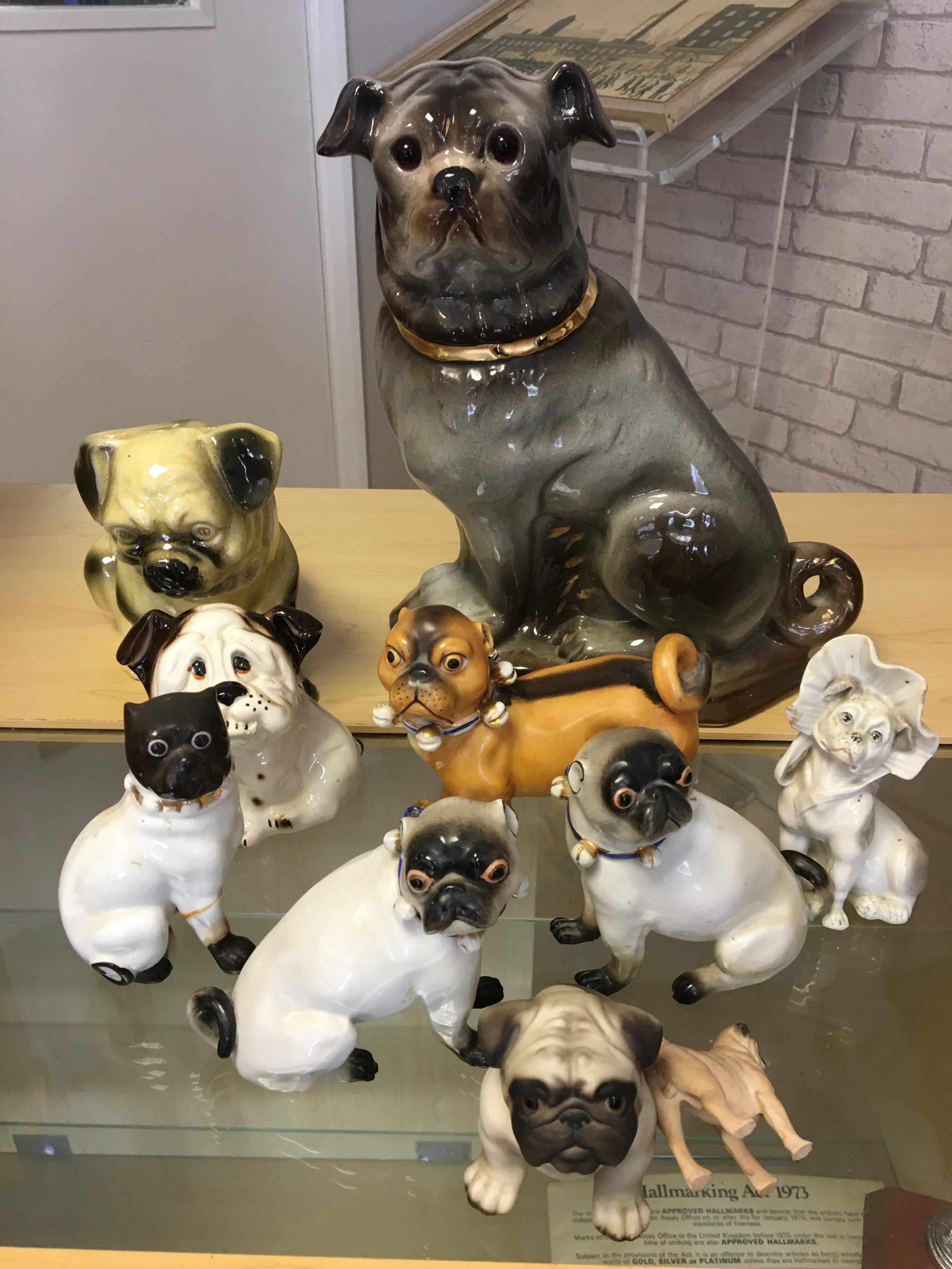 Quantity of pug ceramic dogs to include 19th Century examples.