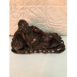 19th c Carved Chinese figure of a man laying with a Tiger.