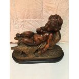 19th C Terracotta figure of a putti sleeping on a chair.