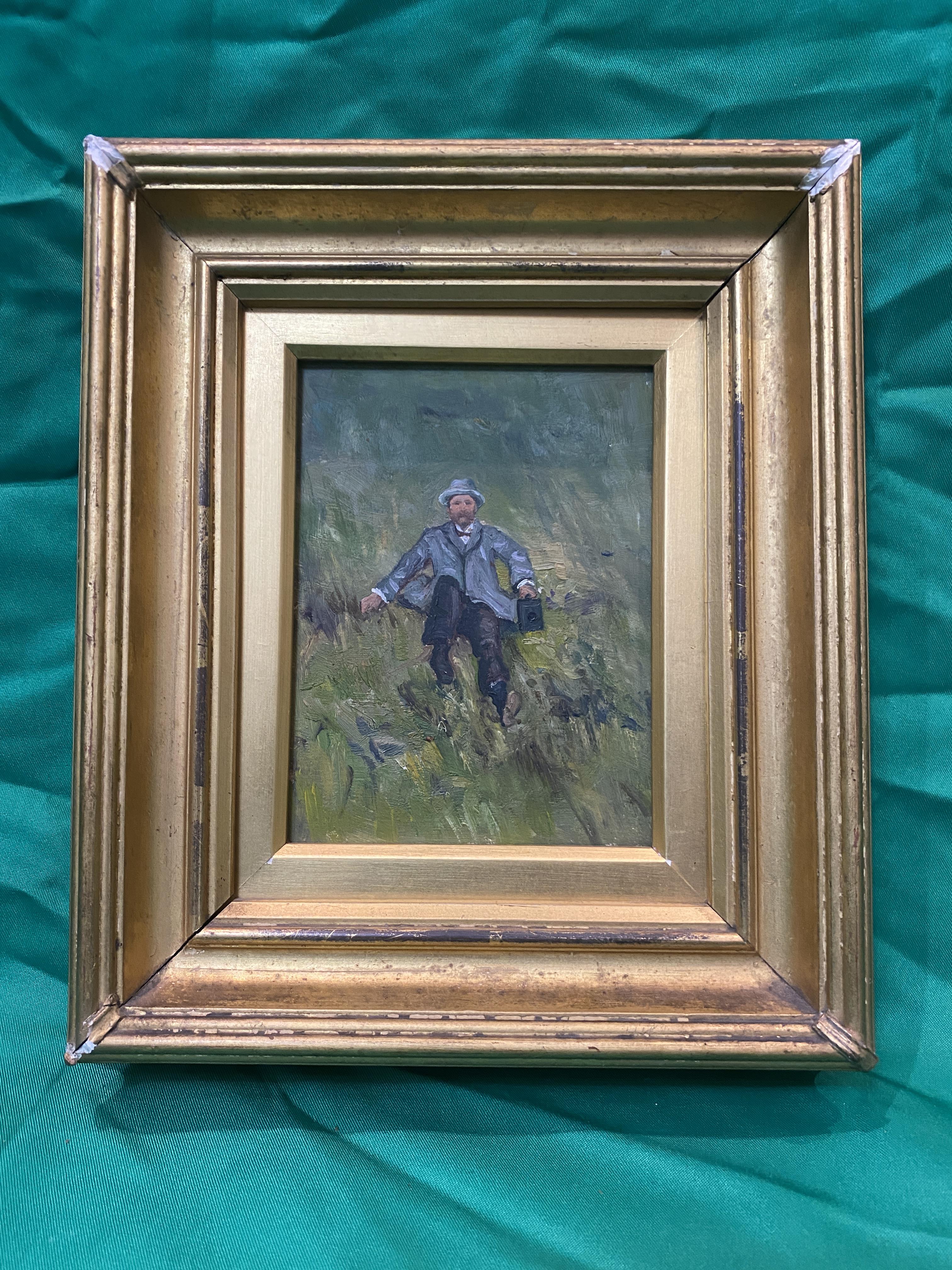 Miniature oil on board of a dressed gentleman in hat sitting on the grass