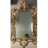 Ornate floral scroll gilt mirror.