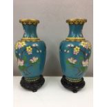 Pair of Chinese cloisonne vases and wooden stands.