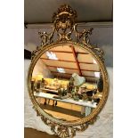 Ornate circular gilded mirror.