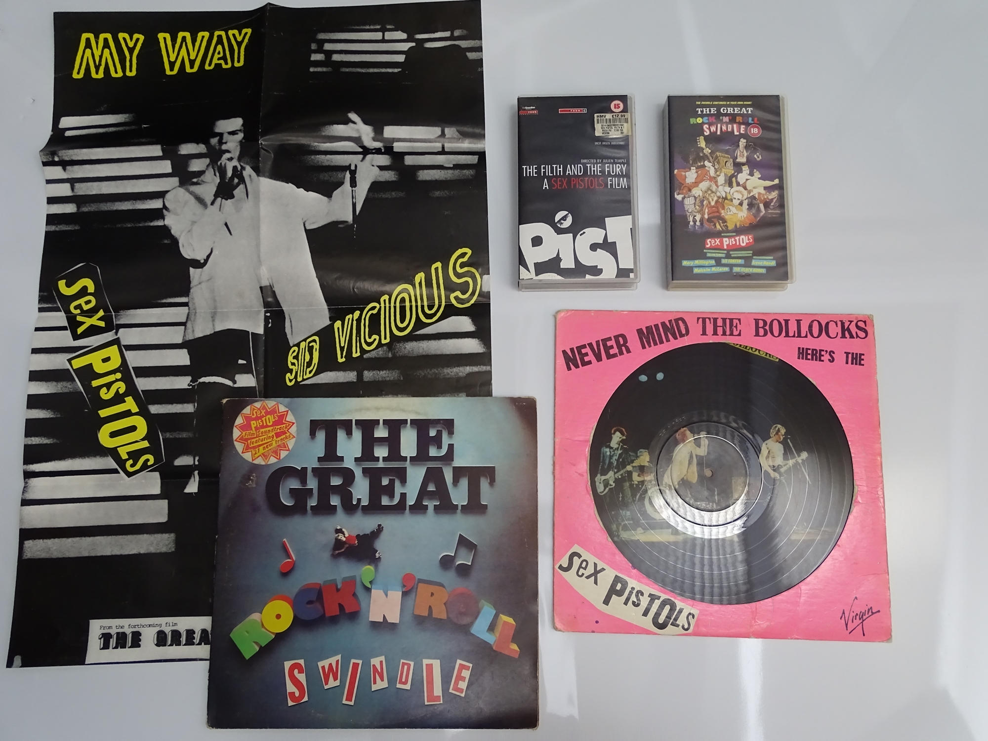 THE SEX PISTOLS: A collection of memorabilia to include: 2 X 12" vinyl LPs, 2 X VHS VIDEOS and 1 x