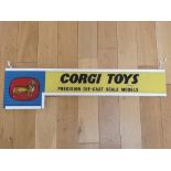 A CORGI Toys glass shop display sign - circa 1960s - mounted in a frame (A/F - Break to glass (