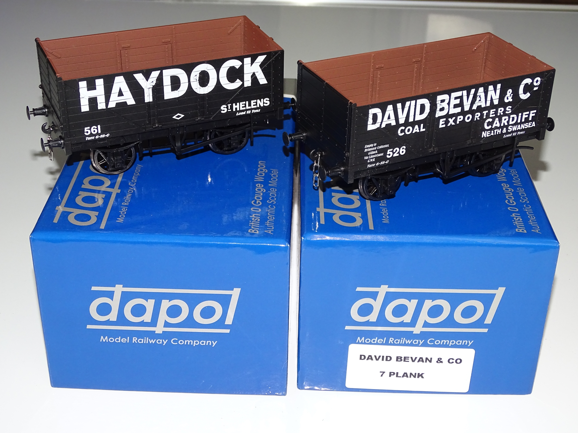 O Gauge Model Railways: A pair of modern DAPOL 7-plank private owner open wagons to include: '