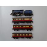 OO GAUGE MODEL RAILWAYS: A small group of TRIX TWIN railway to include: a loco with tender and three