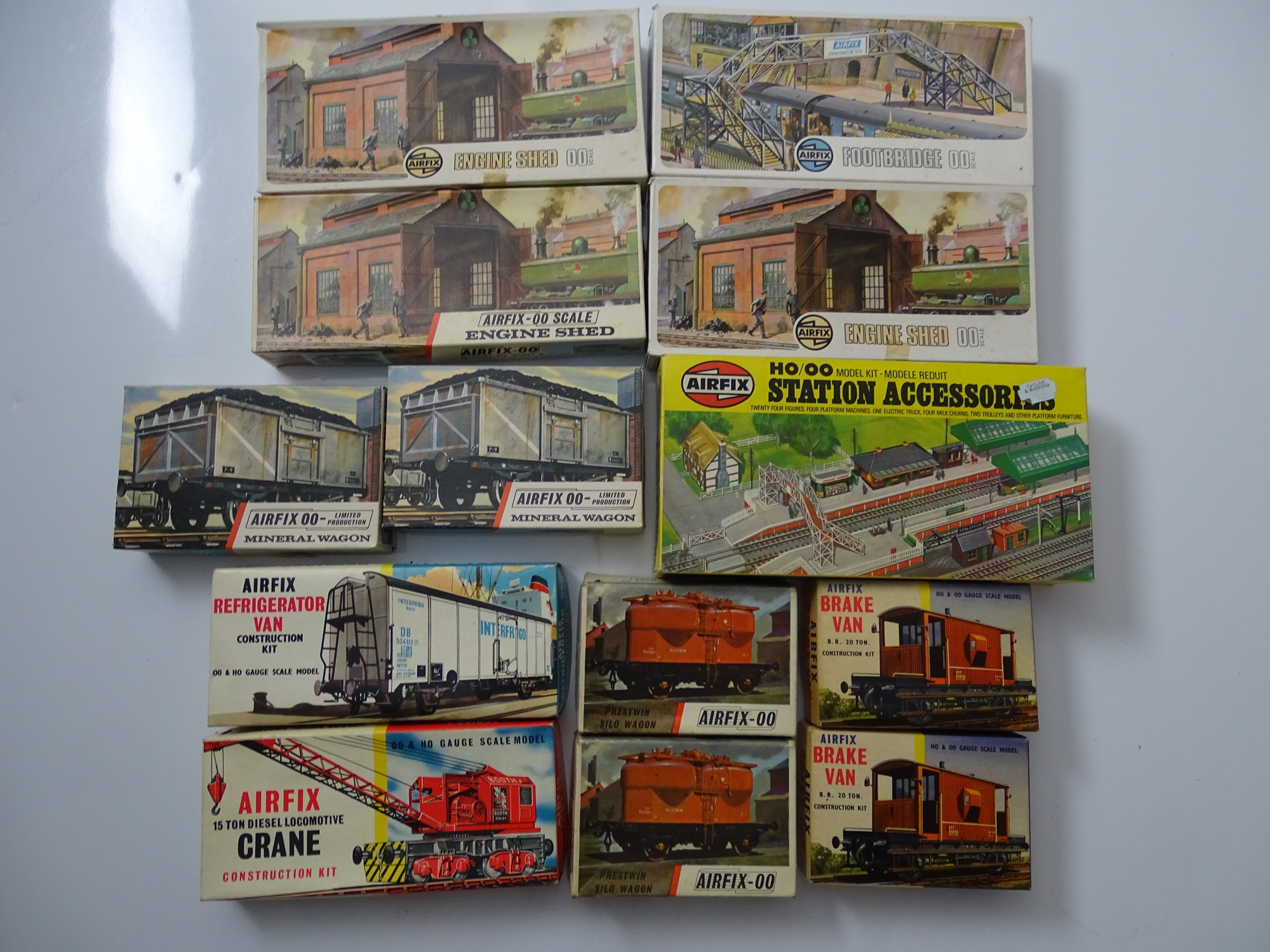 OO GAUGE MODEL RAILWAYS: A group of AIRFIX unbuilt plastic kits comprising wagons, buildings and