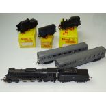 TT GAUGE MODEL RAILWAYS: A group of TRI-ANG Continental locos and rolling stock to include a rare