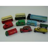 DINKY: A group of playworn DINKY lorries and buses as lotted - repainting apparent to a few,