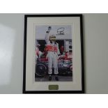 AUTOGRAPH: LEWIS HAMILTON - A framed and glazed signed colour 10 x 8 photograph - this item has been