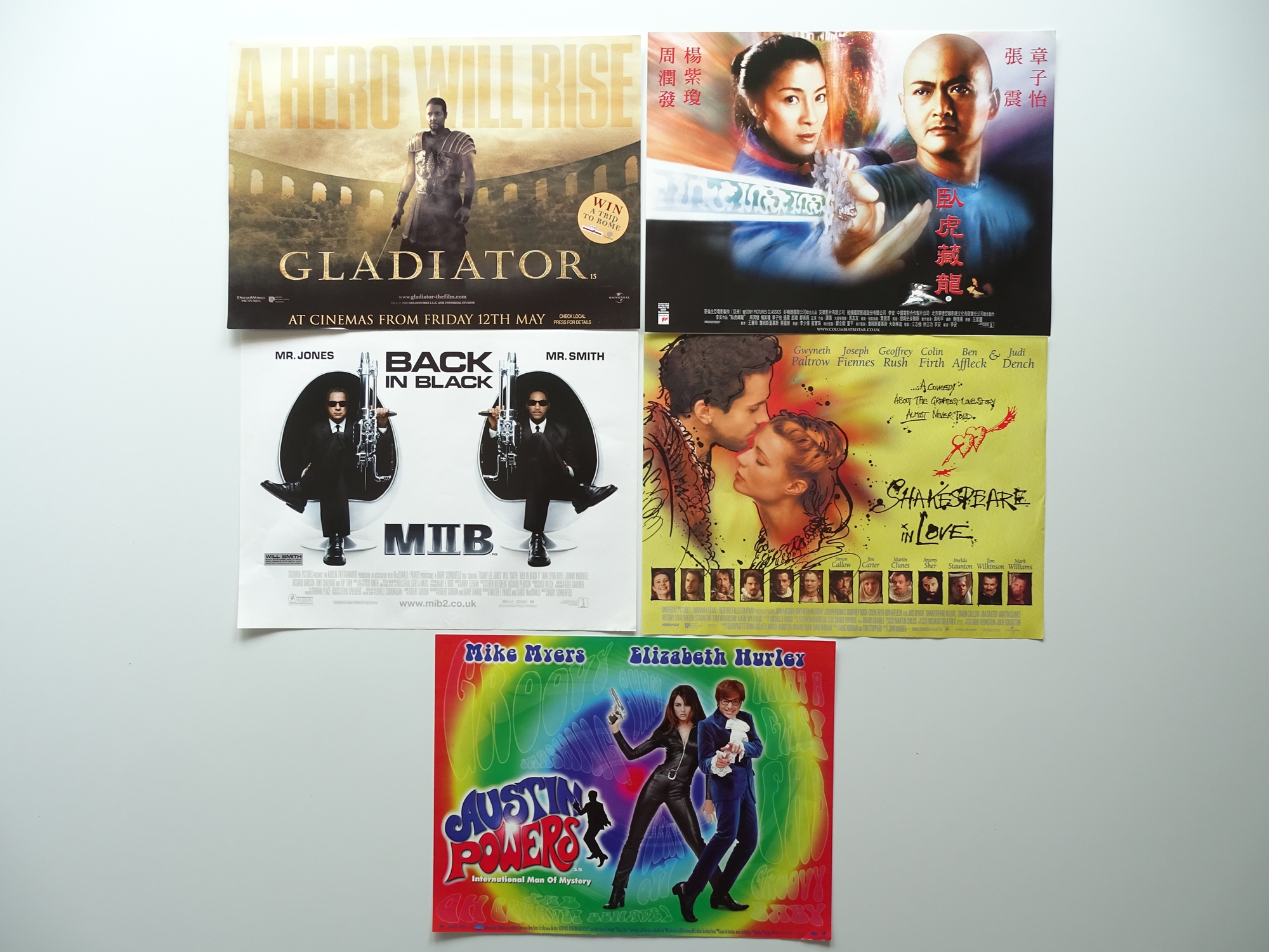 ACTION: A selection of movie memorabilia to include: Five mini posters featuring artwork based on