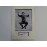 AUTOGRAPH: SIR NORMAN WISDOM - mounted photograph and autograph display - this item has been