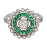 Edwardian style platinum, emerald and diamond cluster ring, central old cut diamond surrounded by c