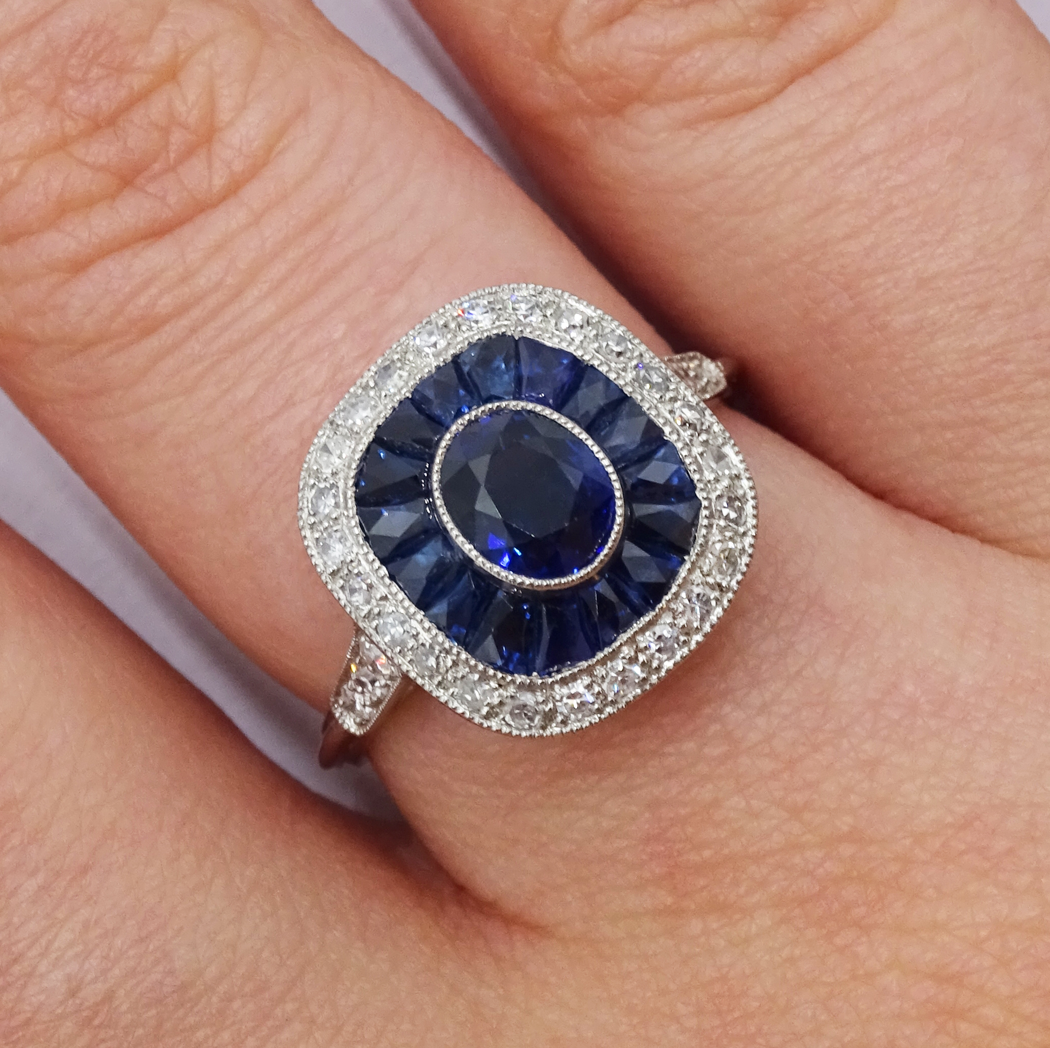 Art Deco style platinum, sapphire and diamond ring, centre oval shaped sapphire surrounded by a hal - Image 2 of 6