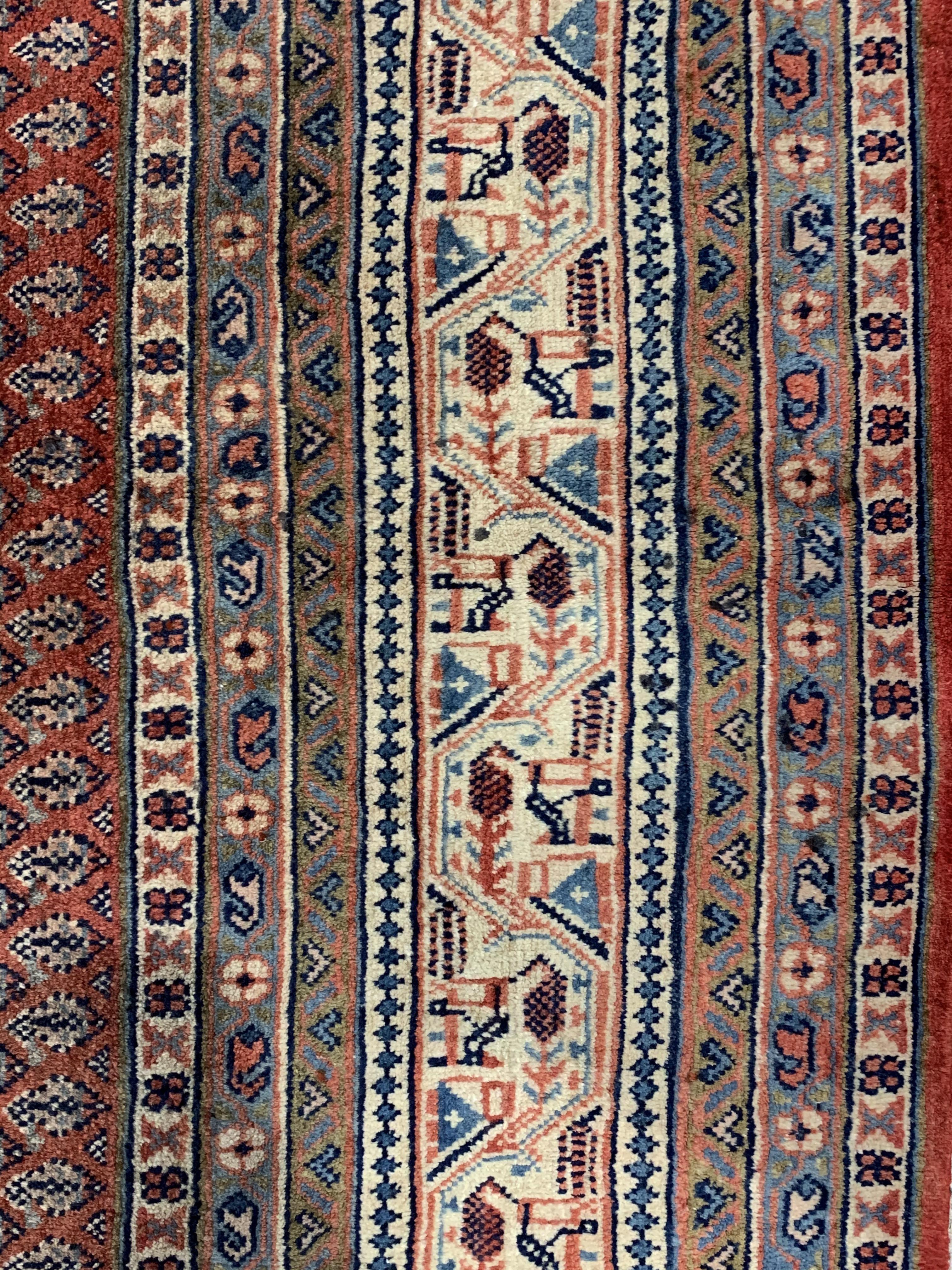 Large Persian Araak carpet, red ground field decorated all over with Boteh motifs, multiple band - Image 3 of 4