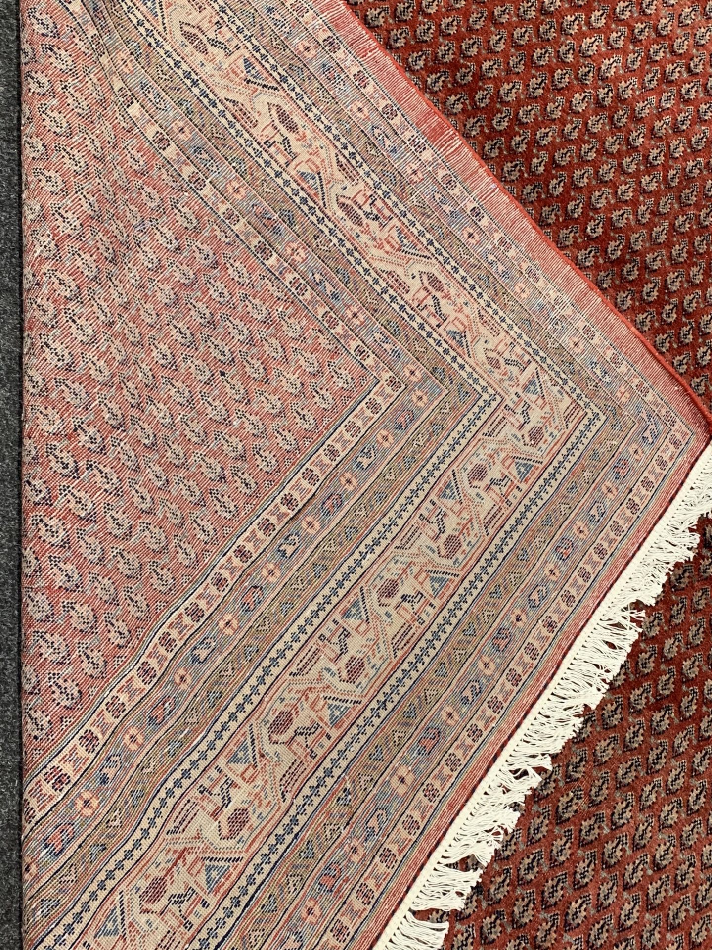 Large Persian Araak carpet, red ground field decorated all over with Boteh motifs, multiple band - Image 4 of 4