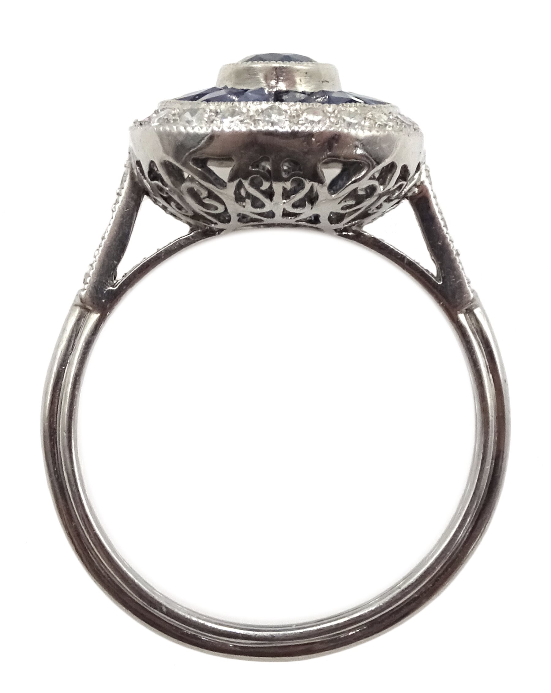 Platinum sapphire and diamond ring, the central oval sapphire surrounded by halo of calibre cut - Image 4 of 5