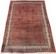 Large Persian Araak carpet, red ground field decorated all over with Boteh motifs, multiple band