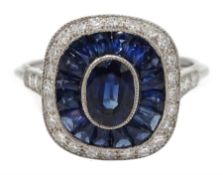 Platinum sapphire and diamond ring, the central oval sapphire surrounded by halo of calibre cut