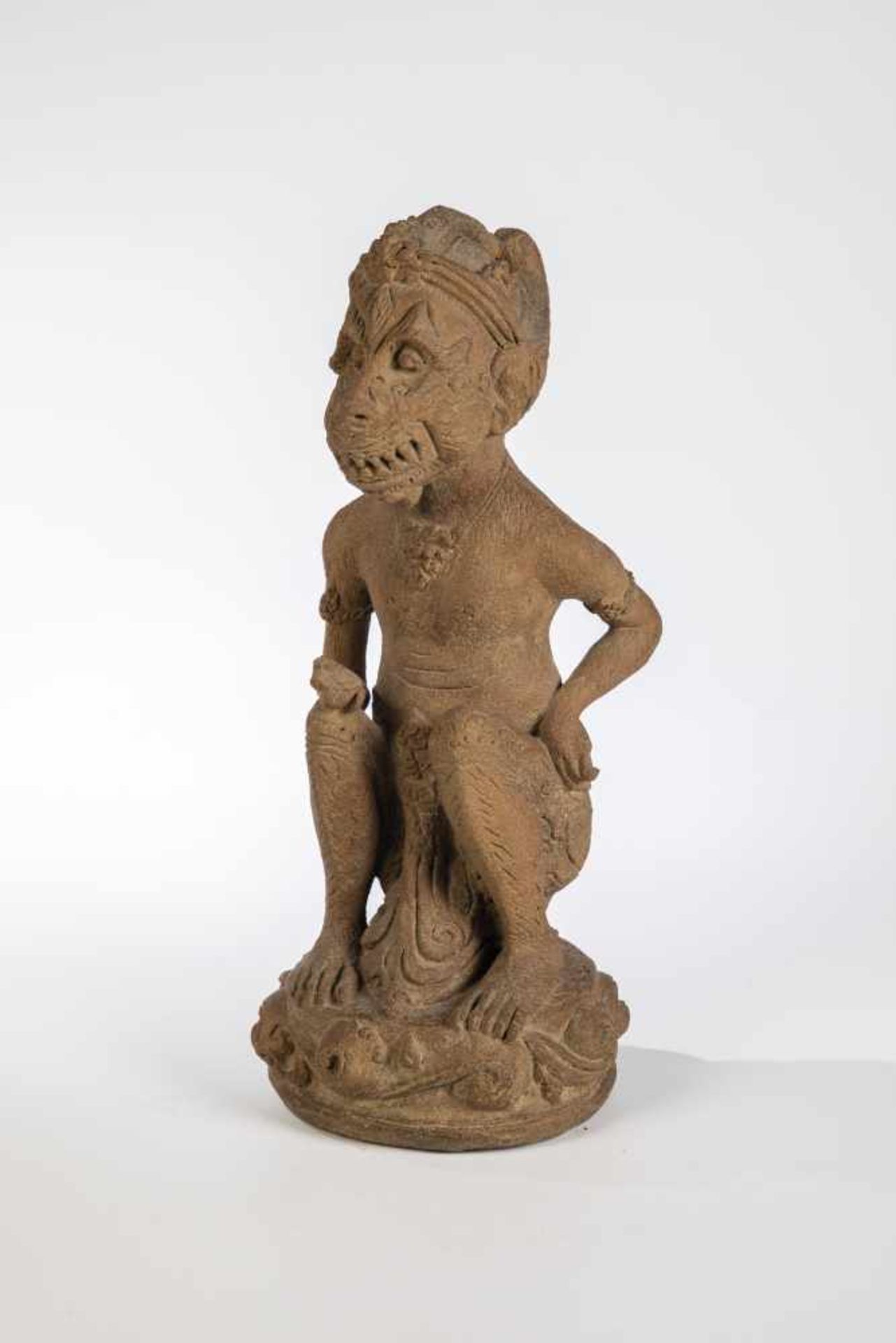 Hanuman. Java, probably 15th century. Squatting monkey god. Terracotta, partly damaged. 30cm high.