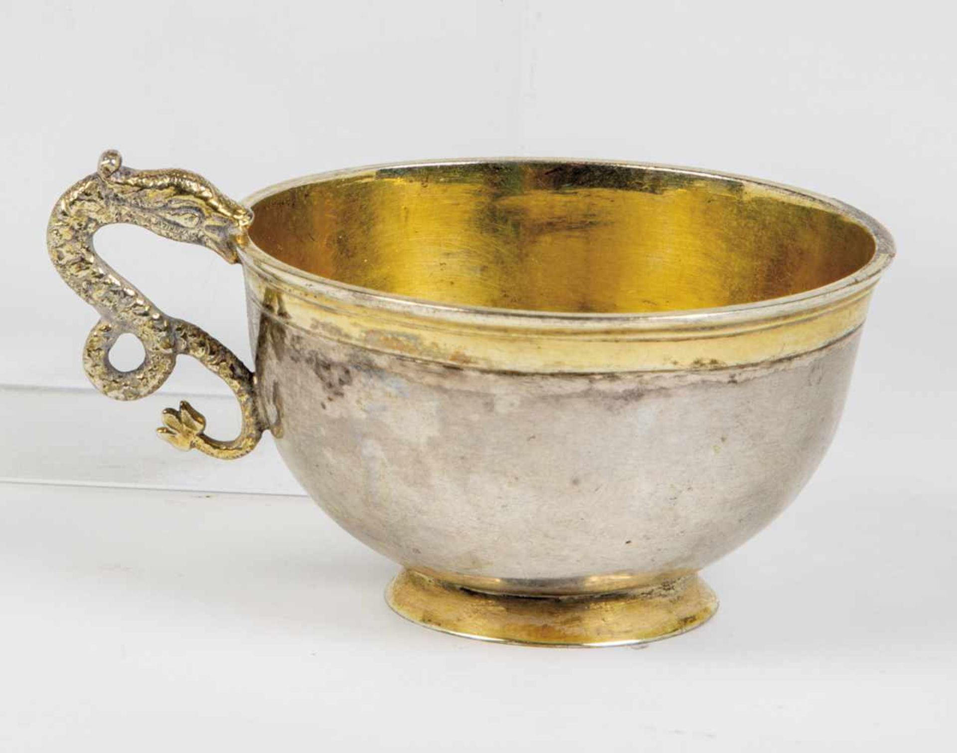 One silver partial-gilt charka. Russia, circa 1800. Snake handle. Bottom with engraving.Unmarked.