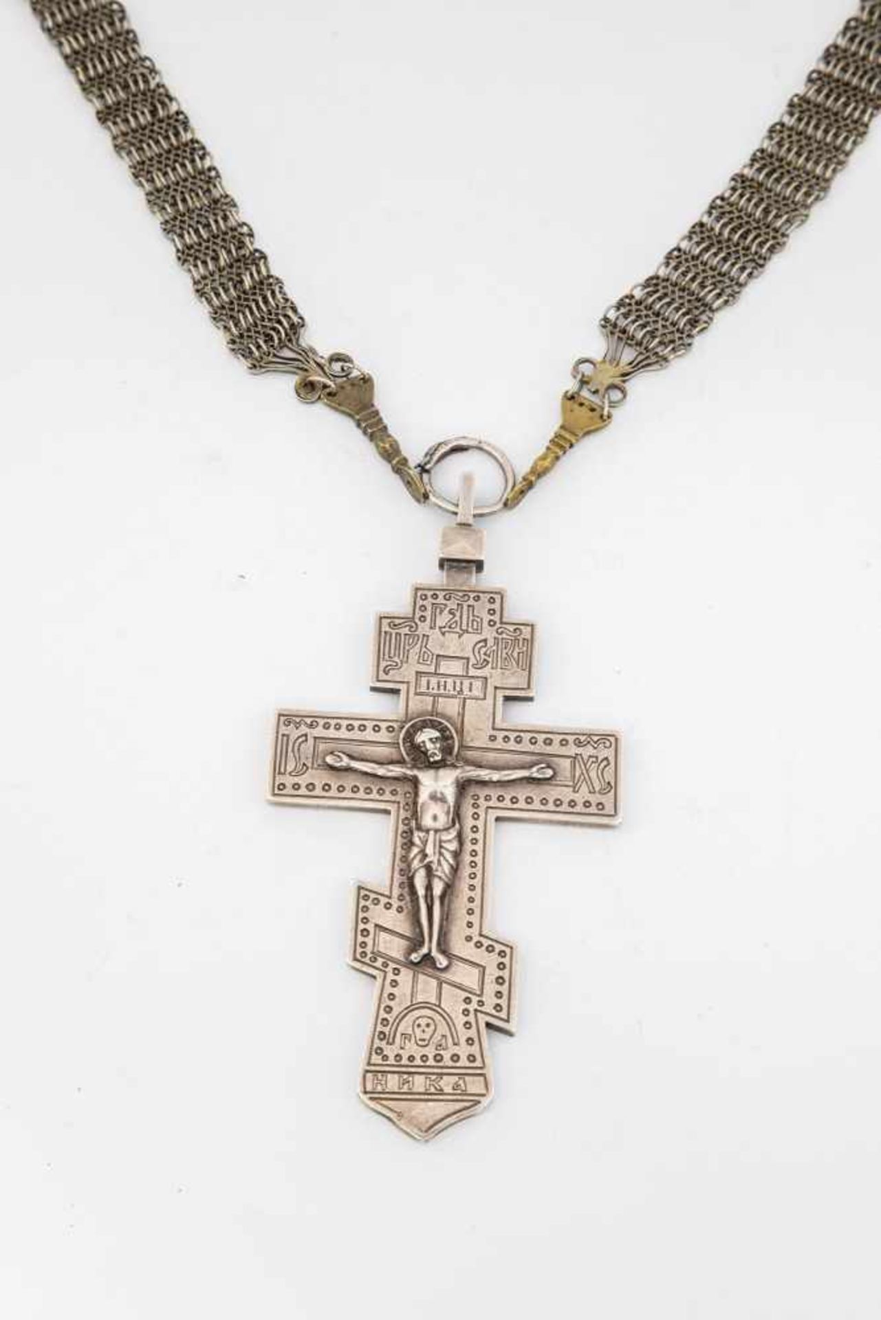 A silver crucifix. Russia, 20th century. Plated chain. Engraved silver cross with appliedchrist
