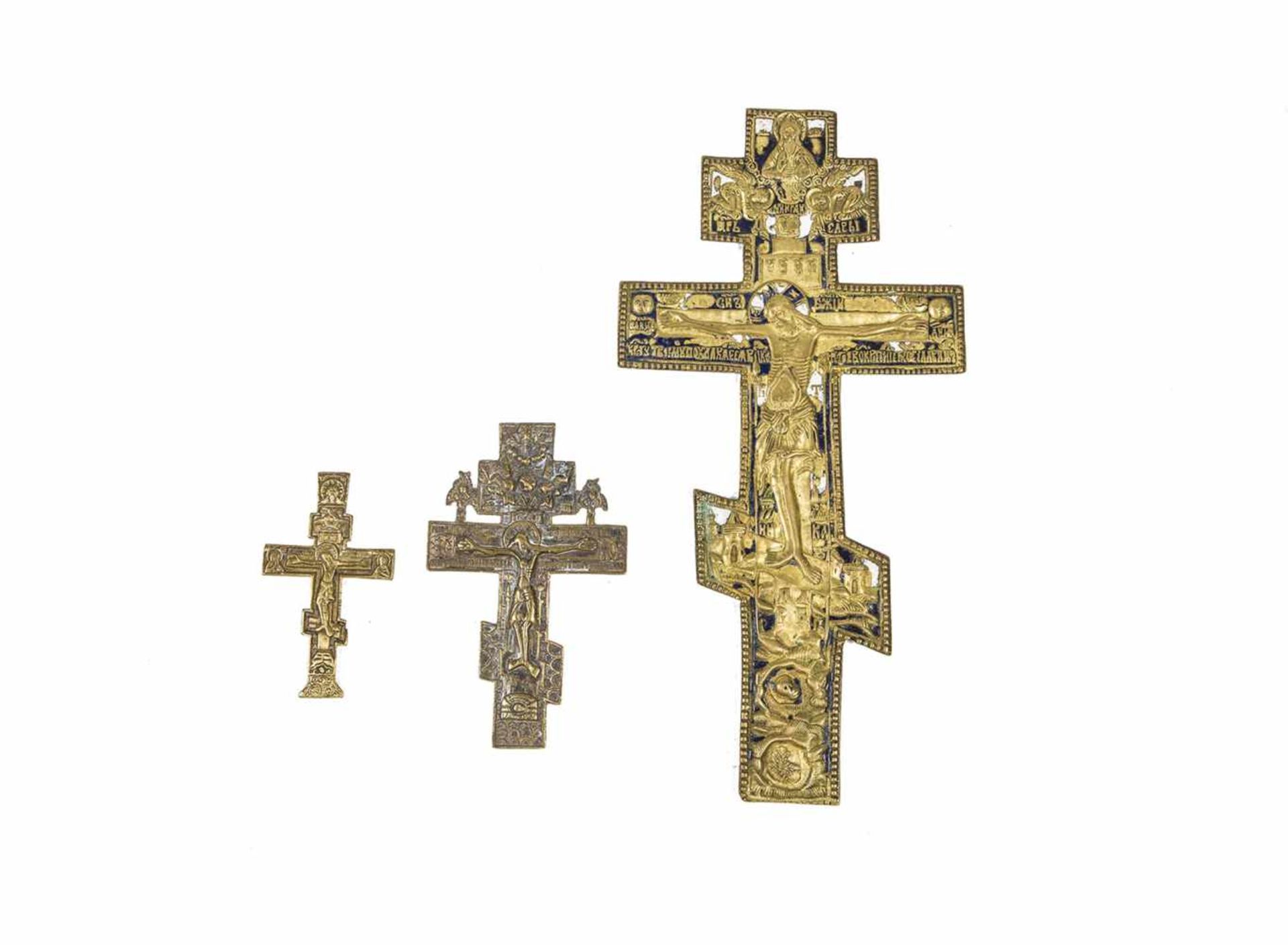 Thee brass crosses. Russia, 18th/19th century. Cast in relief. Large cross with blue andwhite enamel