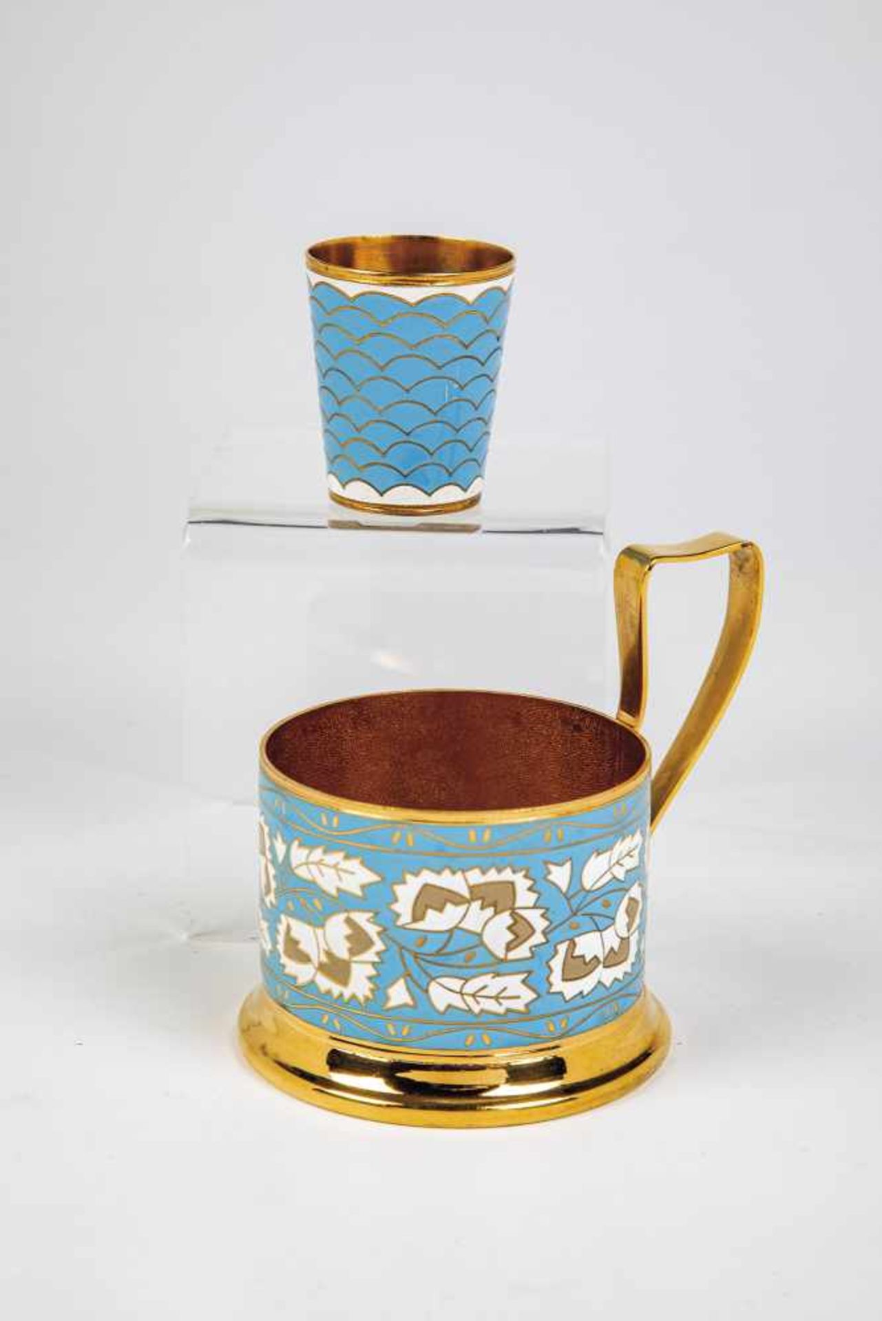 A gilded enamel tea glass holder and vodka beaker. Soviet Union, after 1958. Plated. Bodywith blue