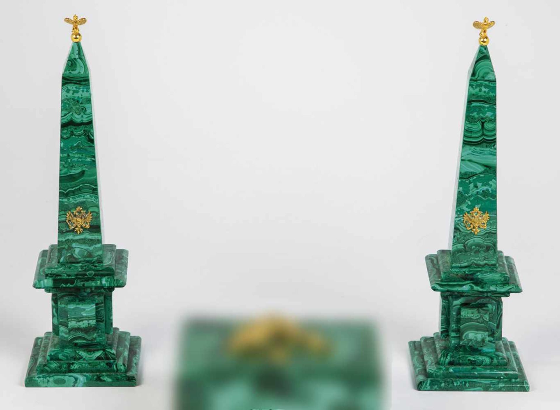 Two malachite obelisks. Russia, 20th century. Applied silver-gilt double-eagle anddouble-eagle at