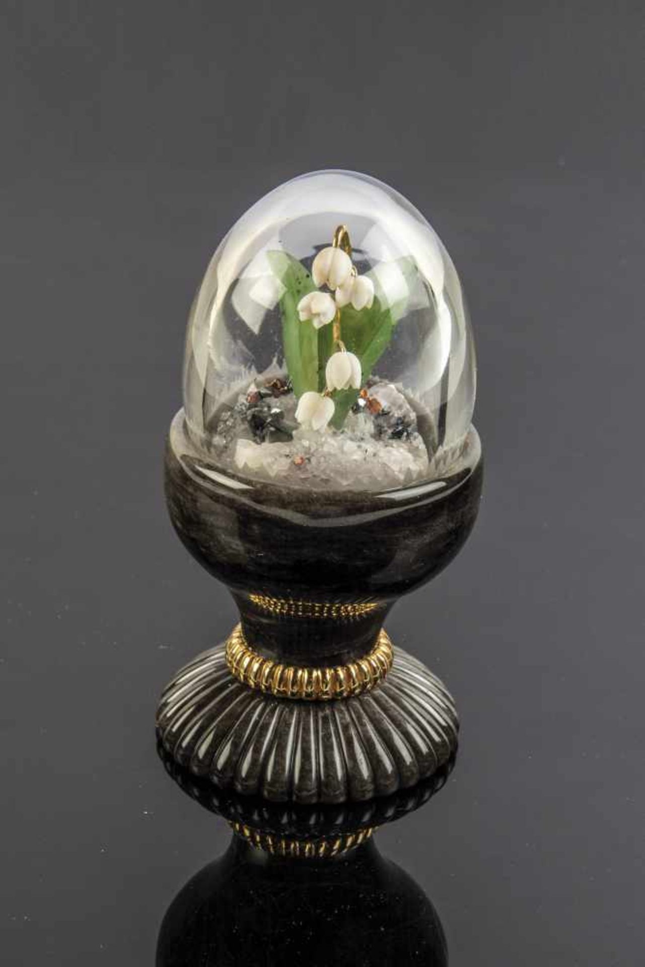 A rock crystal egg with pearl opal flowers. 2nd half of the 20th century. Obsidian-egg cupset with