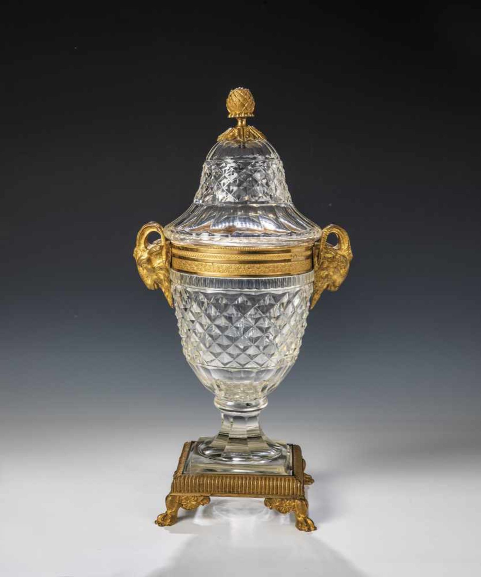 An ormolu mounted glass lidded glass vessel. Russia, circa 1820. On four feet. Colourlesscutted