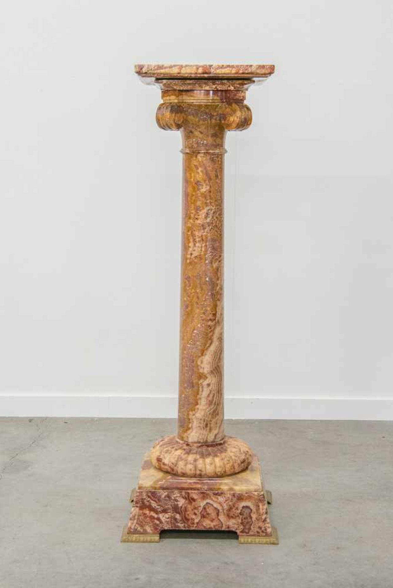 Pedestal made of red Onyx, with a swivel top and standing on bronze feet. Marked, "Fizel". 19th