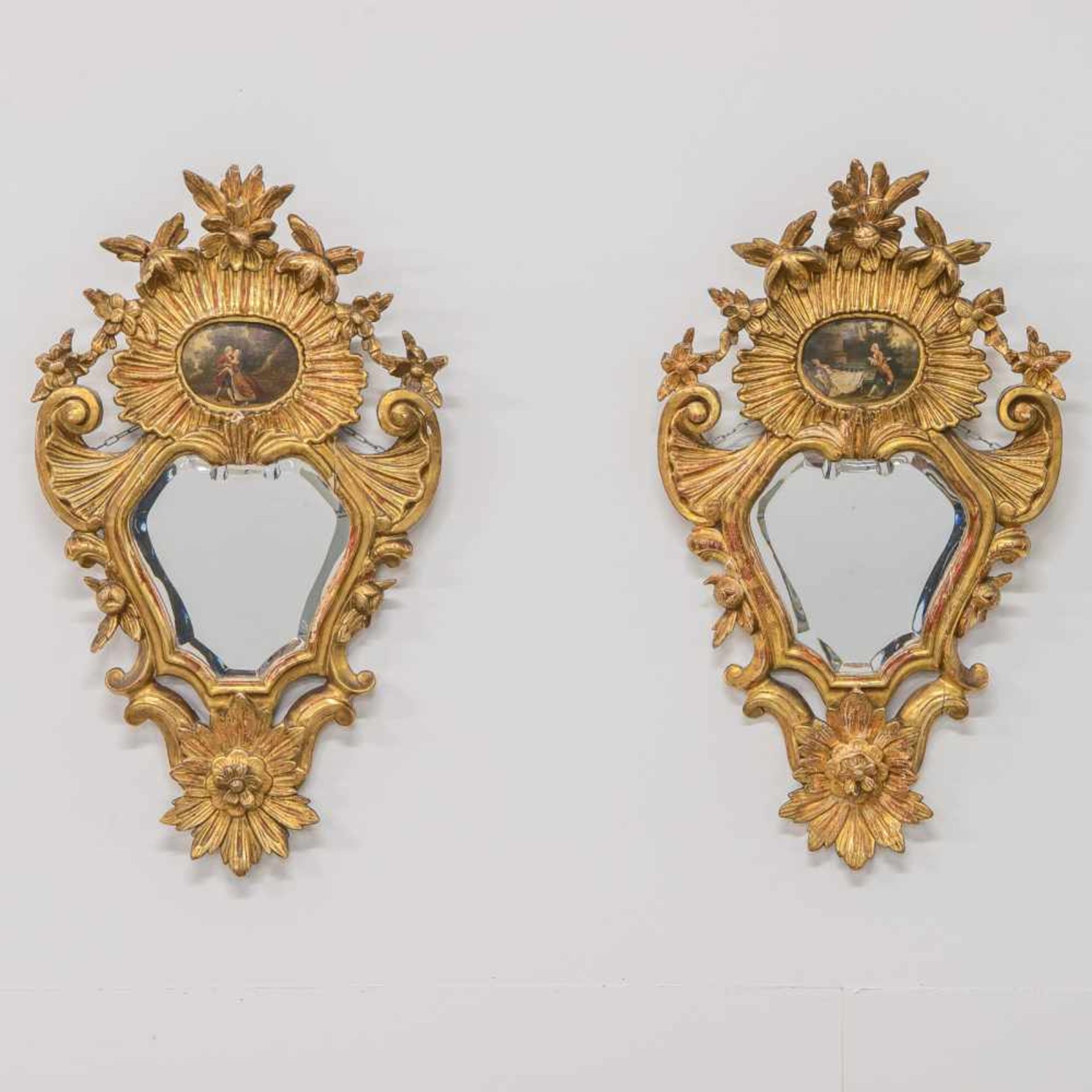 Antique pair of 19th century mirrors, made of sculptured gilt wood with a small painting mounted
