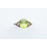 An Oval Peridot & Chip Diamond Ring,