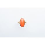 A Yellow Metal Oval Orange Coral Ring,