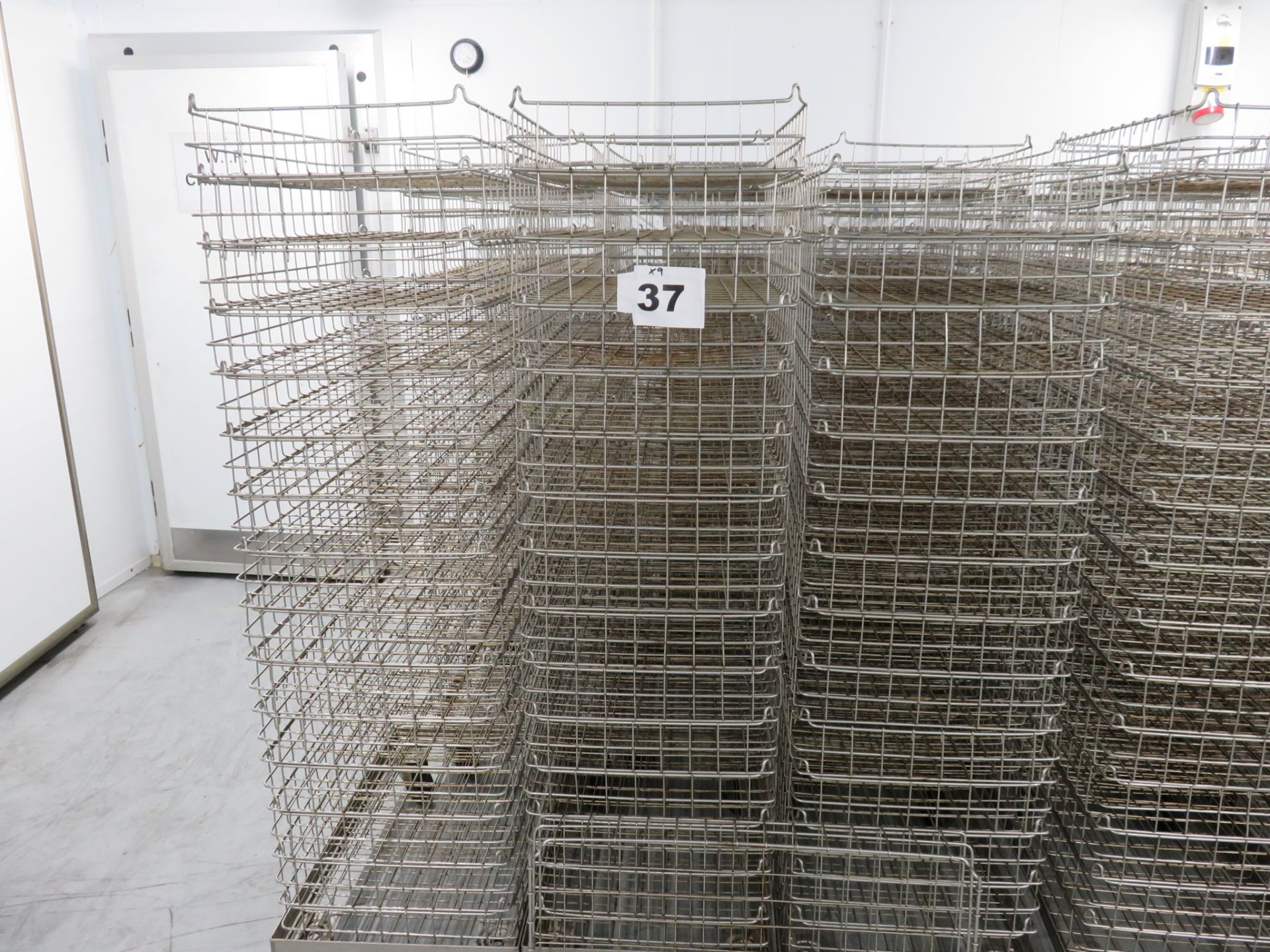 QUANTITY OF INTERLOCKING MESH BASKETS ON DOLLIES.