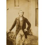 Photographs.- Man standing on steps in front of arched doorway with spaniel, ?salt print, [1850s] …