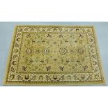Contemporary woollen rug, the beige field with allover foliate pattern, 120 x 179cm