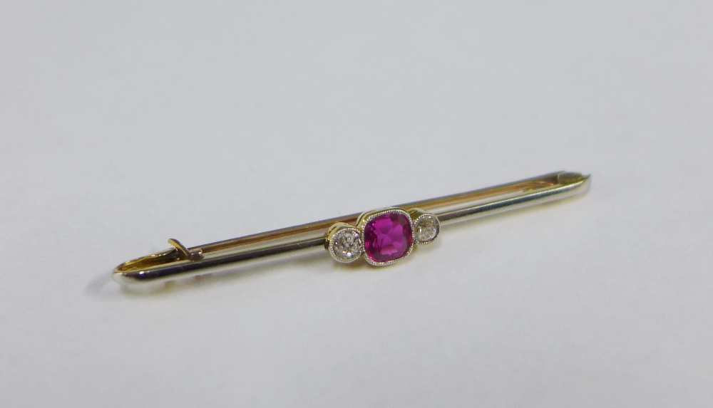 Early 20th century gold and platinum bar brooch, collet set with a cushion cut ruby flanked by