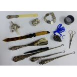 A collection of silver and white metal items to include a baby's rattle, pill box, page turners,