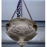A white stoneware ceiling light shade, with moulded leaf and flower pattern