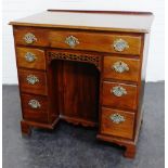 Georgian mahogany kneehole desk, the rectangular top with ledgeback and moulded edge, over a