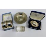 Three Birmingham silver napkin rings, a silver Brandy decanter label and a QEII silver armada