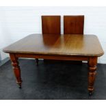 Mahogany extending dining table, the rectangular top with moulded edge, on bold baluster legs